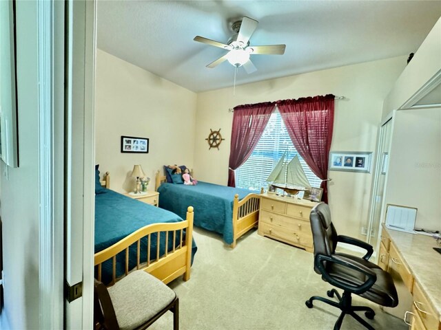 bedroom featuring ceiling fan and carpet