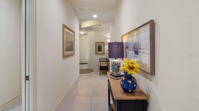 hall featuring recessed lighting, visible vents, baseboards, and tile patterned floors