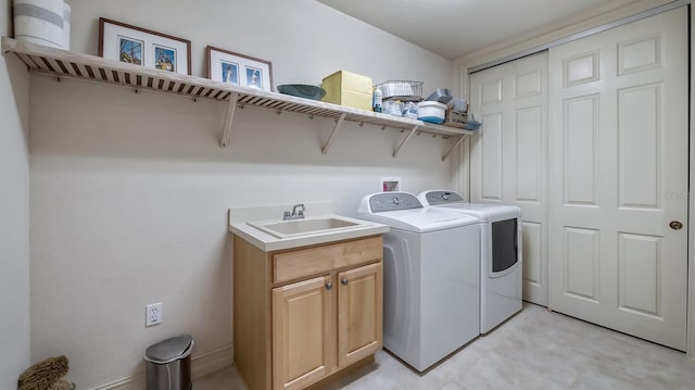 laundry area featuring a sink, cabinet space, and washer and dryer