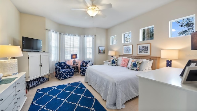 bedroom with a ceiling fan and light carpet