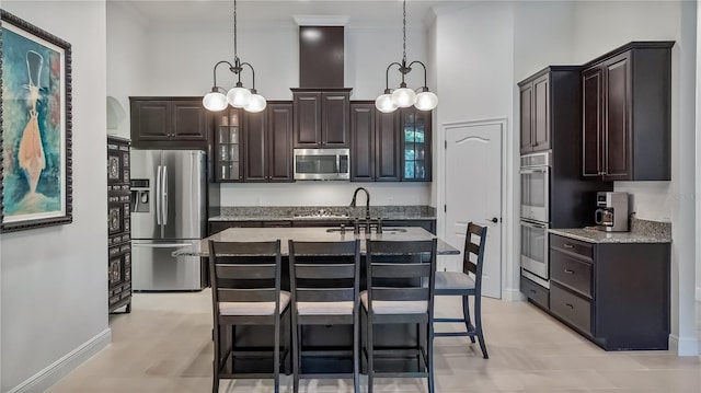 kitchen featuring appliances with stainless steel finishes, a towering ceiling, dark brown cabinetry, and crown molding