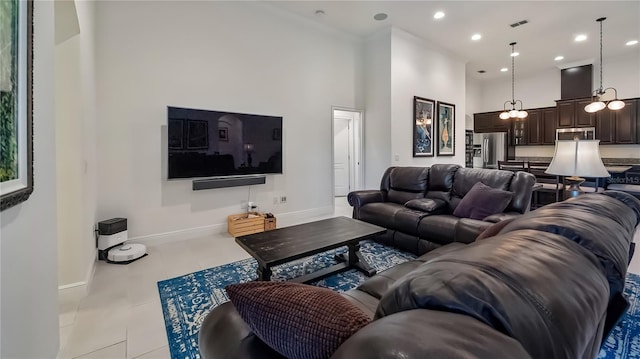 living room featuring tile patterned flooring, recessed lighting, a towering ceiling, visible vents, and baseboards