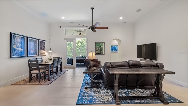 living room with arched walkways, recessed lighting, a ceiling fan, and baseboards