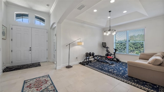 exercise area with arched walkways, recessed lighting, a raised ceiling, visible vents, and baseboards