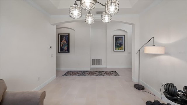 interior space featuring baseboards, visible vents, arched walkways, and crown molding