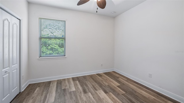 empty room featuring ceiling fan, wood finished floors, and baseboards