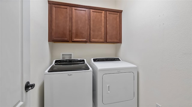 washroom featuring cabinet space and independent washer and dryer