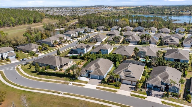 drone / aerial view featuring a water view and a residential view