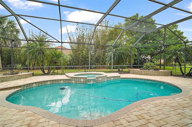 view of pool featuring glass enclosure, a pool with connected hot tub, and a patio