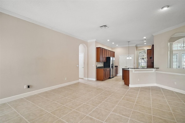 kitchen with dark countertops, visible vents, stainless steel refrigerator with ice dispenser, and open floor plan