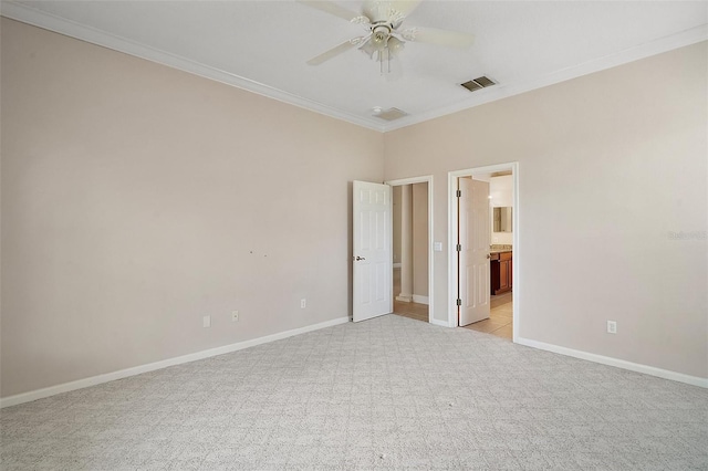 unfurnished bedroom with light colored carpet, visible vents, crown molding, and baseboards