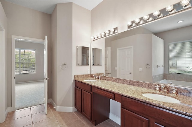 full bath with double vanity, a bath, a sink, and tile patterned floors