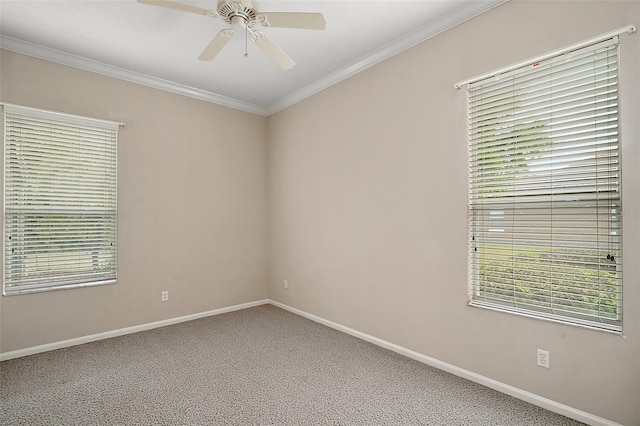 empty room with a healthy amount of sunlight, ceiling fan, ornamental molding, and baseboards