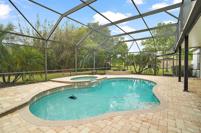 view of pool with a patio area, a lanai, and a pool with connected hot tub