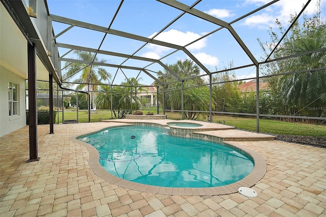 view of swimming pool featuring a patio area, a pool with connected hot tub, and glass enclosure