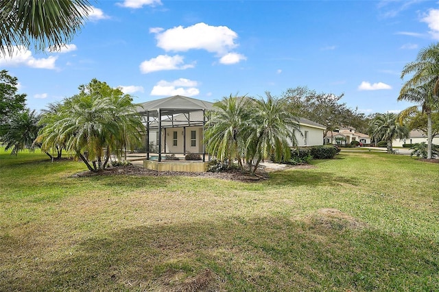 exterior space featuring a lanai and a yard