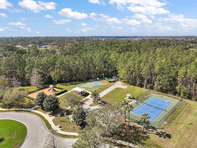 drone / aerial view with a wooded view