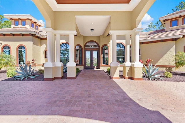 property entrance with french doors and stucco siding