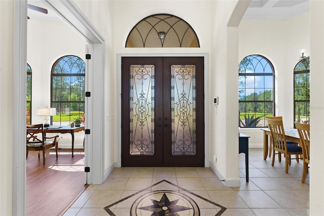 foyer with french doors, baseboards, and a healthy amount of sunlight