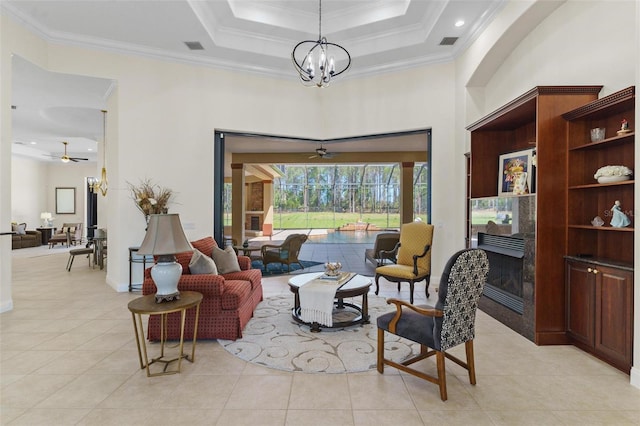 living room with crown molding, light tile patterned flooring, visible vents, and a premium fireplace