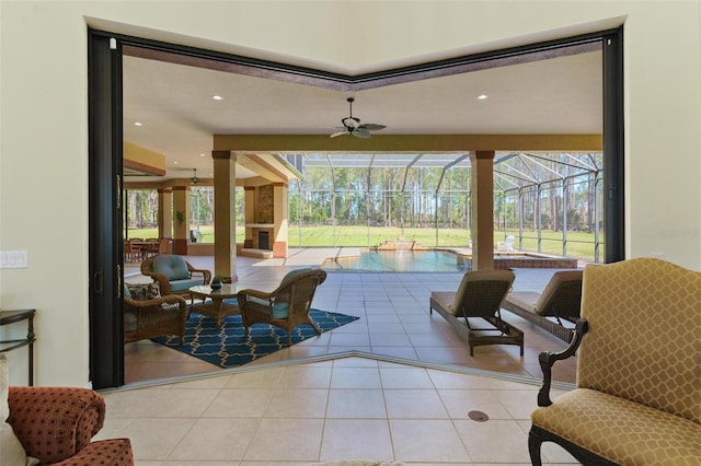 interior space with tile patterned floors, plenty of natural light, a ceiling fan, and a sunroom