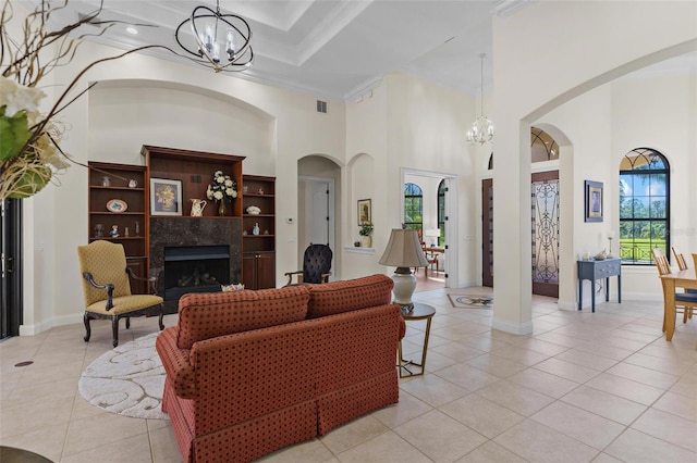 living room featuring crown molding, light tile patterned floors, visible vents, and a chandelier