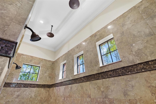 details featuring a tile shower and ornamental molding