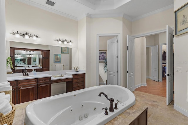 bathroom with visible vents, ornamental molding, a towering ceiling, a tub with jets, and vanity