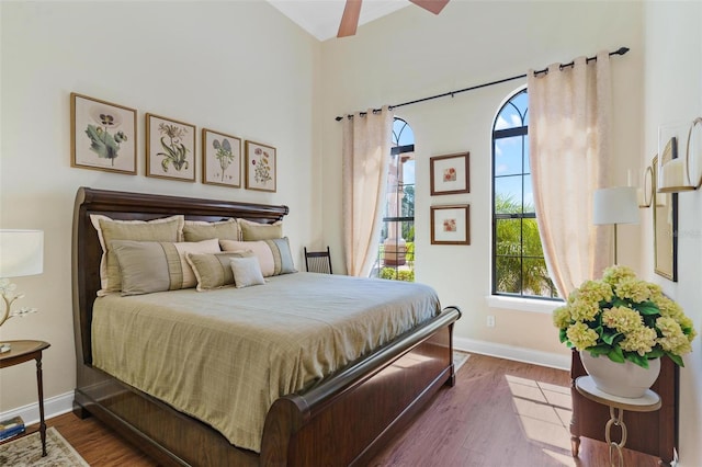 bedroom with dark wood-type flooring and baseboards