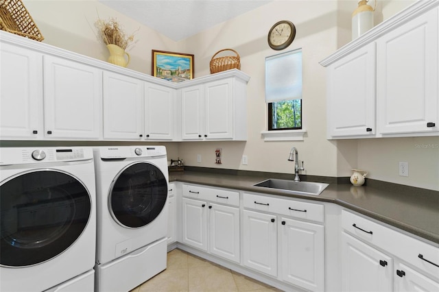 clothes washing area featuring washer and clothes dryer, light tile patterned flooring, cabinet space, and a sink