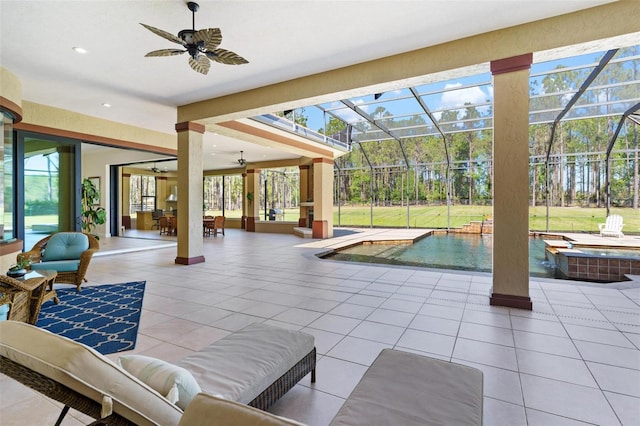 interior space with an outdoor pool, a lanai, an in ground hot tub, and ceiling fan