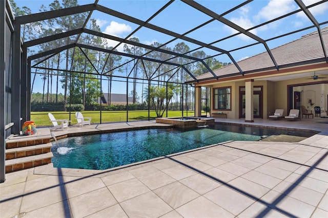 view of pool featuring a lanai, a pool with connected hot tub, ceiling fan, and a patio area