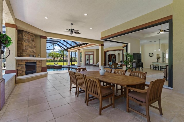 dining area with ceiling fan, a sunroom, recessed lighting, a textured wall, and light tile patterned flooring