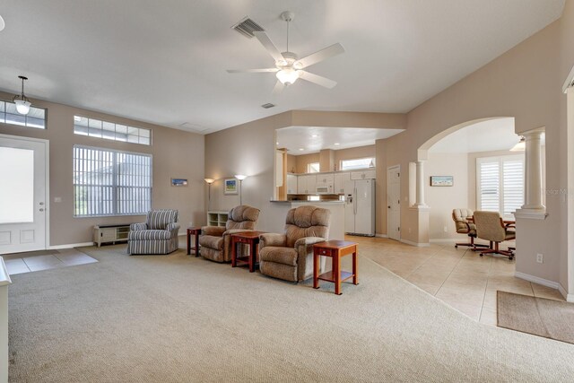 living room featuring light tile patterned floors, light colored carpet, visible vents, and ornate columns