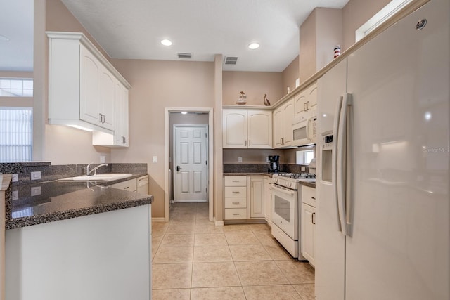 kitchen featuring white appliances, light tile patterned floors, visible vents, a sink, and recessed lighting