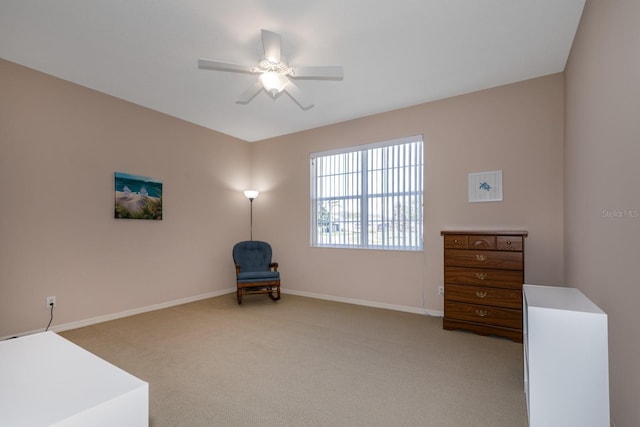 unfurnished room featuring light carpet, ceiling fan, and baseboards