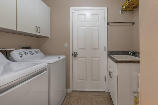 laundry room featuring cabinet space, washer and clothes dryer, a sink, and light tile patterned flooring