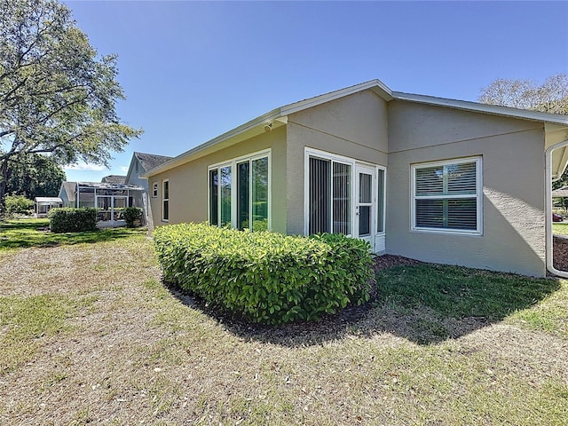 view of side of home featuring stucco siding