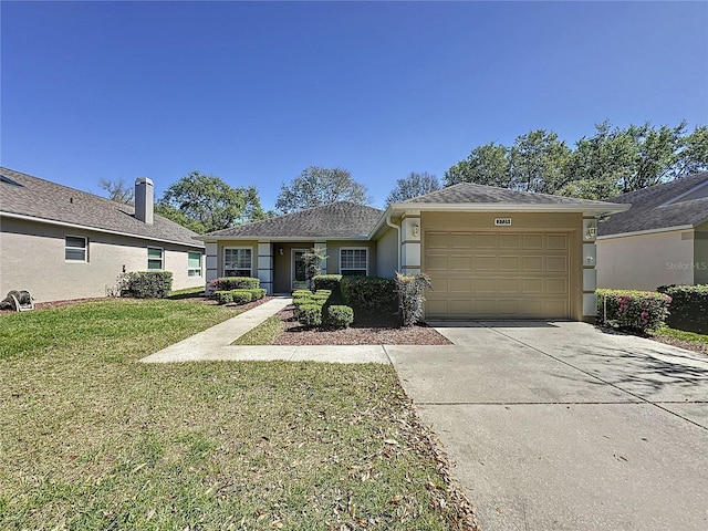 ranch-style home with an attached garage, concrete driveway, a front yard, and stucco siding