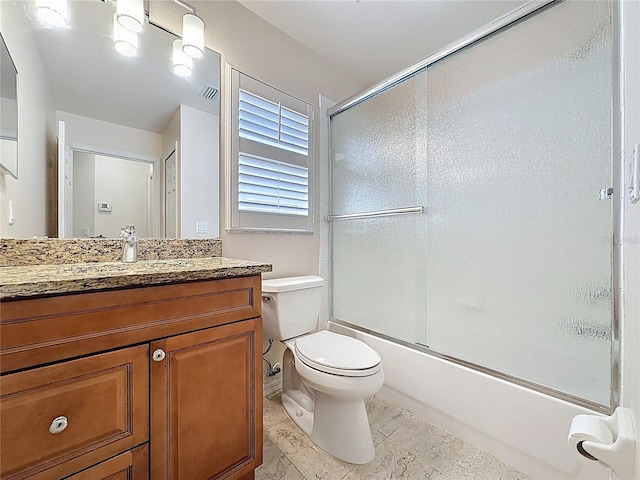 bathroom featuring enclosed tub / shower combo, visible vents, vanity, and toilet