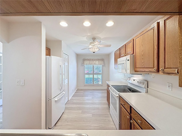 kitchen featuring ceiling fan, white appliances, light countertops, light wood-type flooring, and brown cabinetry