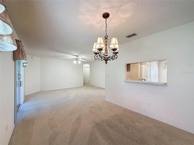 unfurnished room featuring light colored carpet, visible vents, a textured ceiling, baseboards, and ceiling fan with notable chandelier