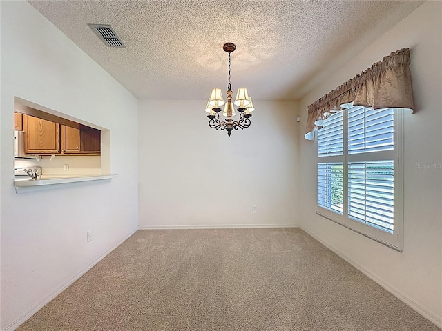 unfurnished room featuring a notable chandelier, visible vents, light carpet, a textured ceiling, and baseboards