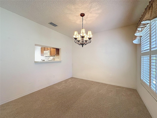 empty room featuring a textured ceiling, light carpet, visible vents, baseboards, and an inviting chandelier