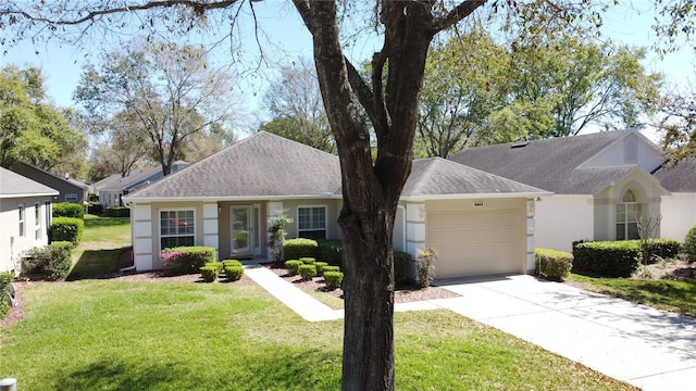 ranch-style home with an attached garage, a shingled roof, concrete driveway, stucco siding, and a front lawn