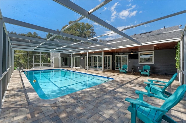 pool featuring glass enclosure and a patio area