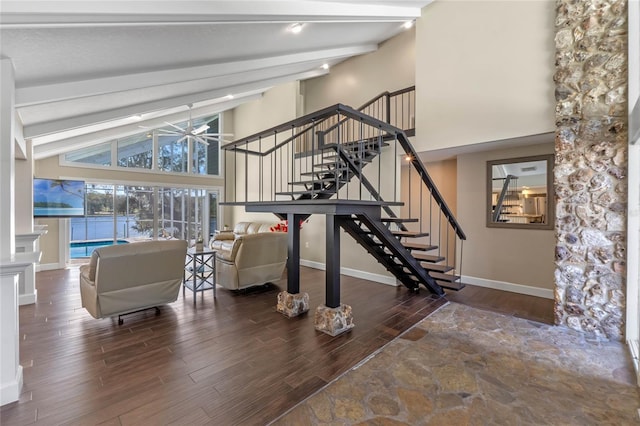 interior space featuring high vaulted ceiling, beamed ceiling, wood finished floors, and baseboards