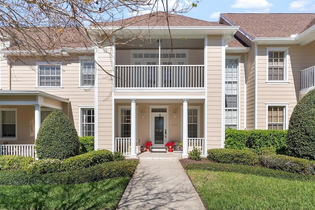 view of front of property featuring covered porch and a shingled roof