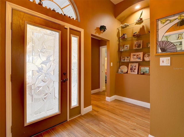 entryway featuring baseboards and light wood finished floors