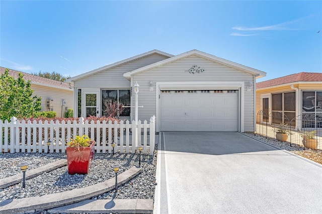 ranch-style home featuring a garage, fence, and concrete driveway